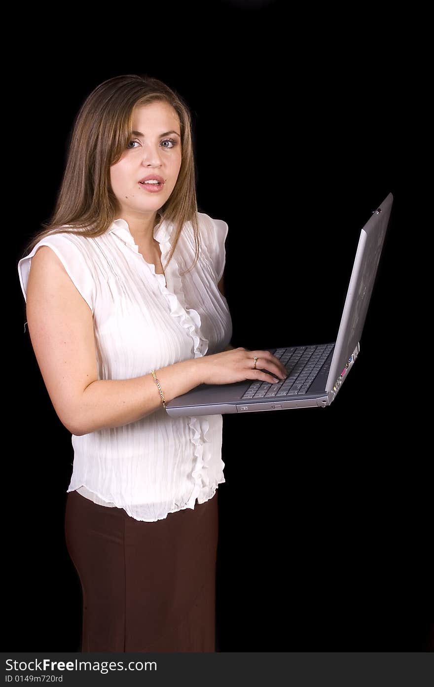 Young hispanic woman with a laptop isolated on black