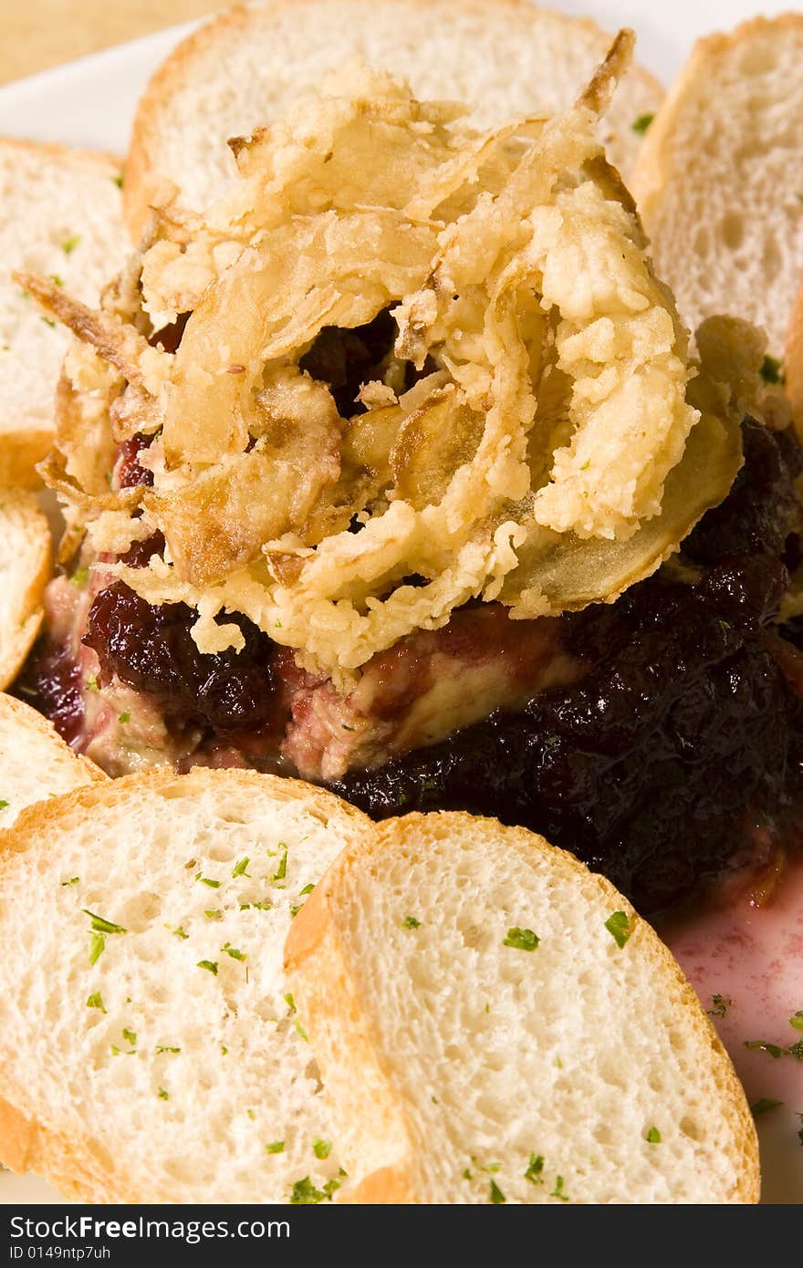 A pate plate with cranberry sauce and bread slices