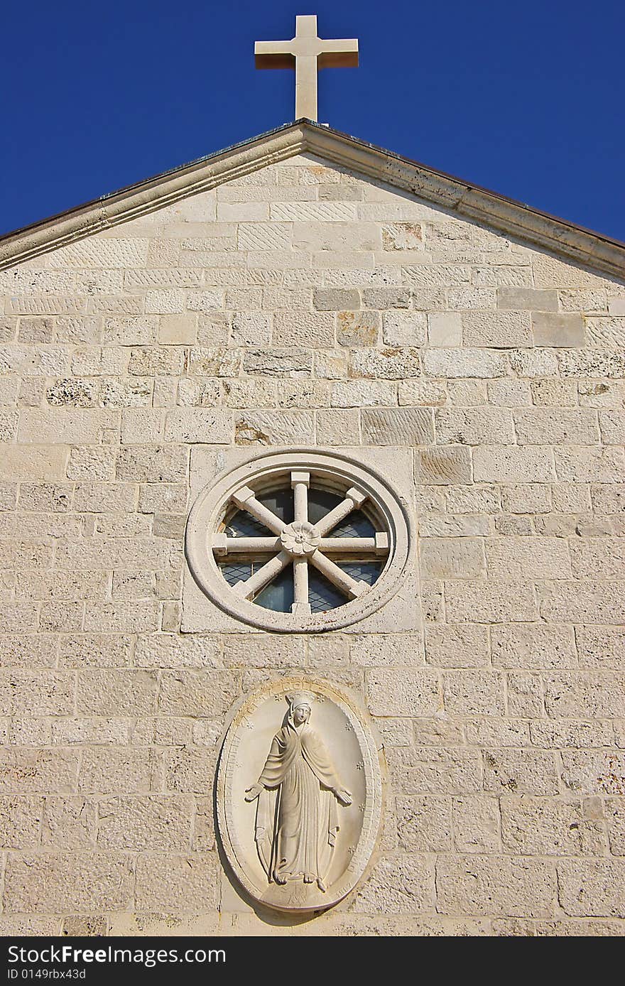 On a photo belltower  on a background of the blue sky.