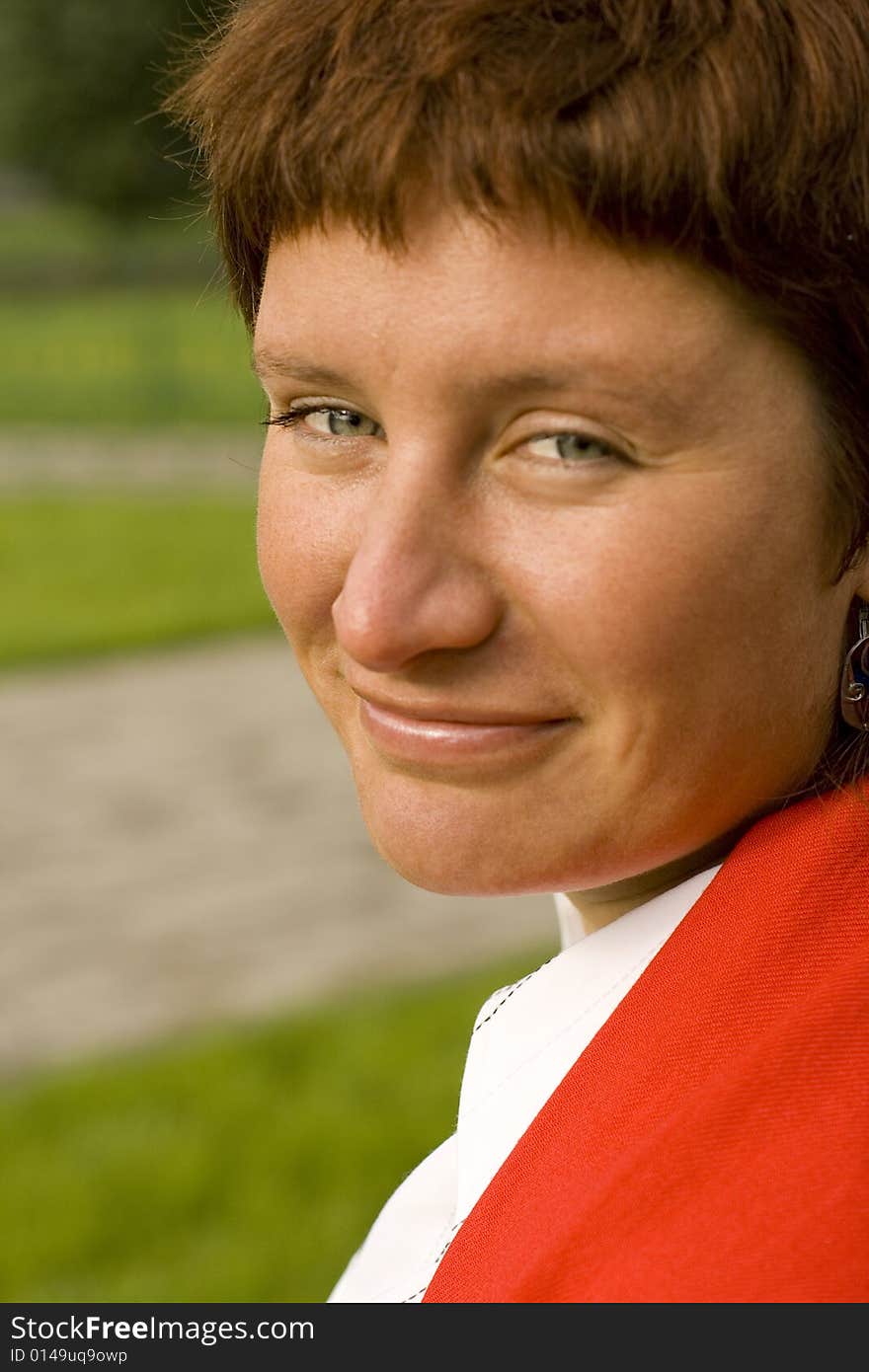 Outdoor portrait of redhead woman in red