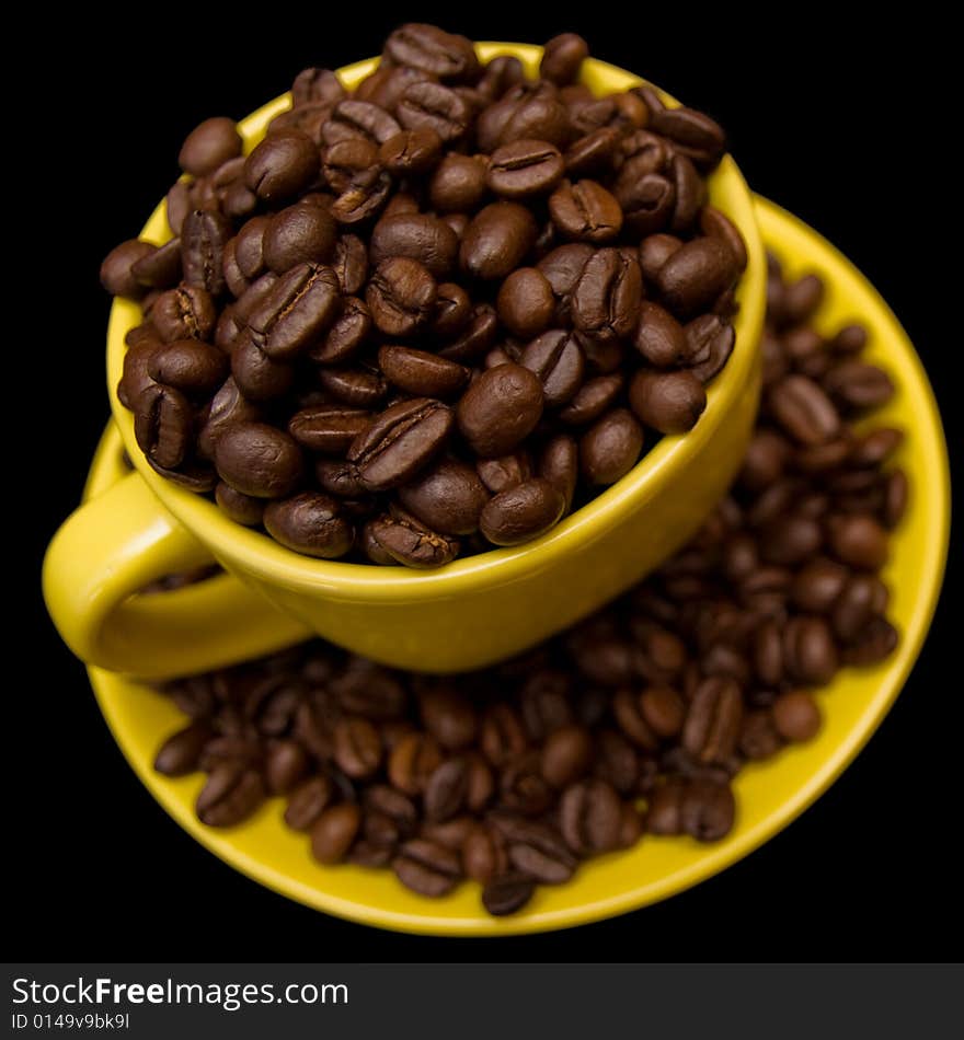 Coffee beans in a yellow cup