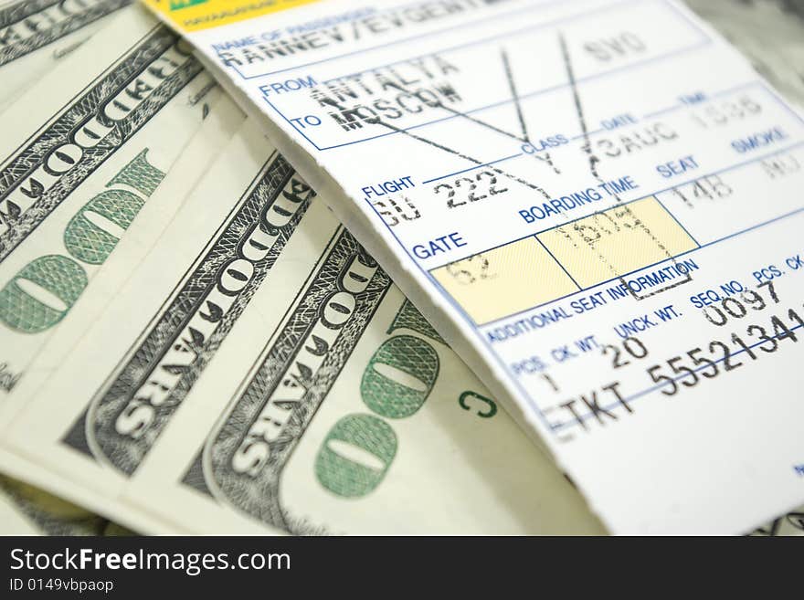 Airplane ticket and dollars