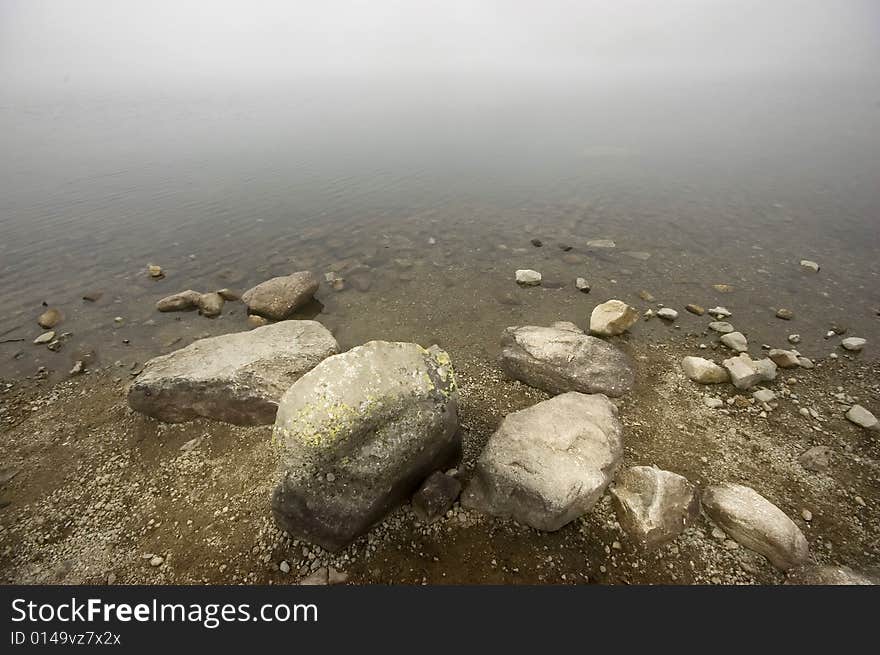 Mountain lake covered in mist, detail