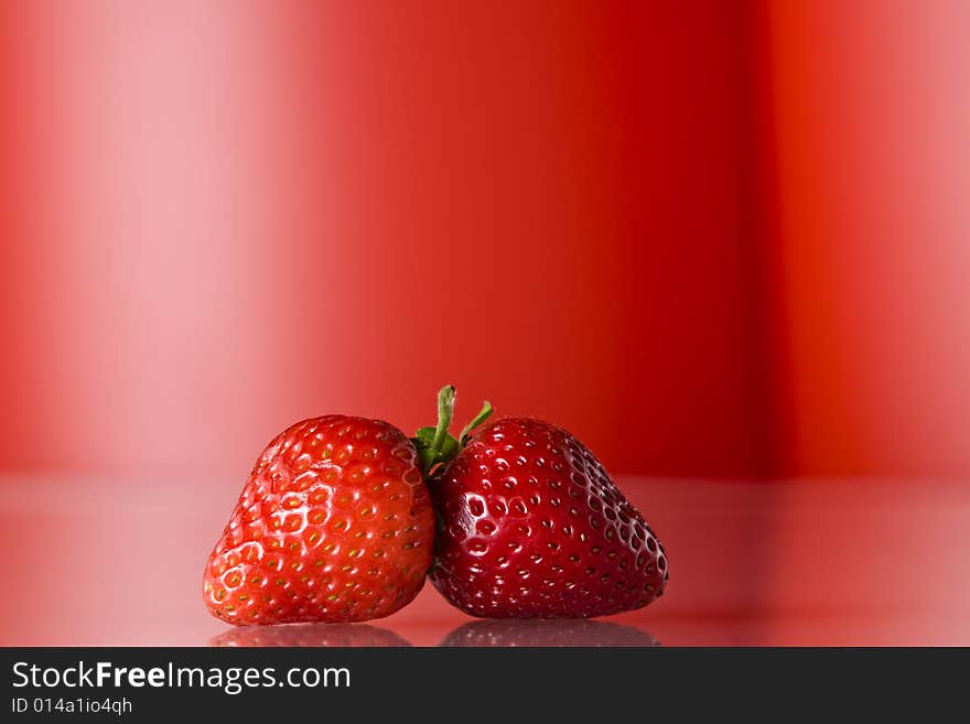 Close up view of nice fresh red berry on red back. Close up view of nice fresh red berry on red back