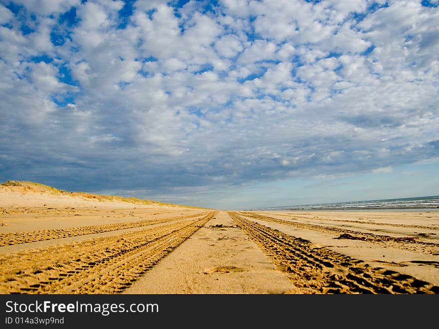 4WD Tracks going over the horizon on the beach. 4WD Tracks going over the horizon on the beach