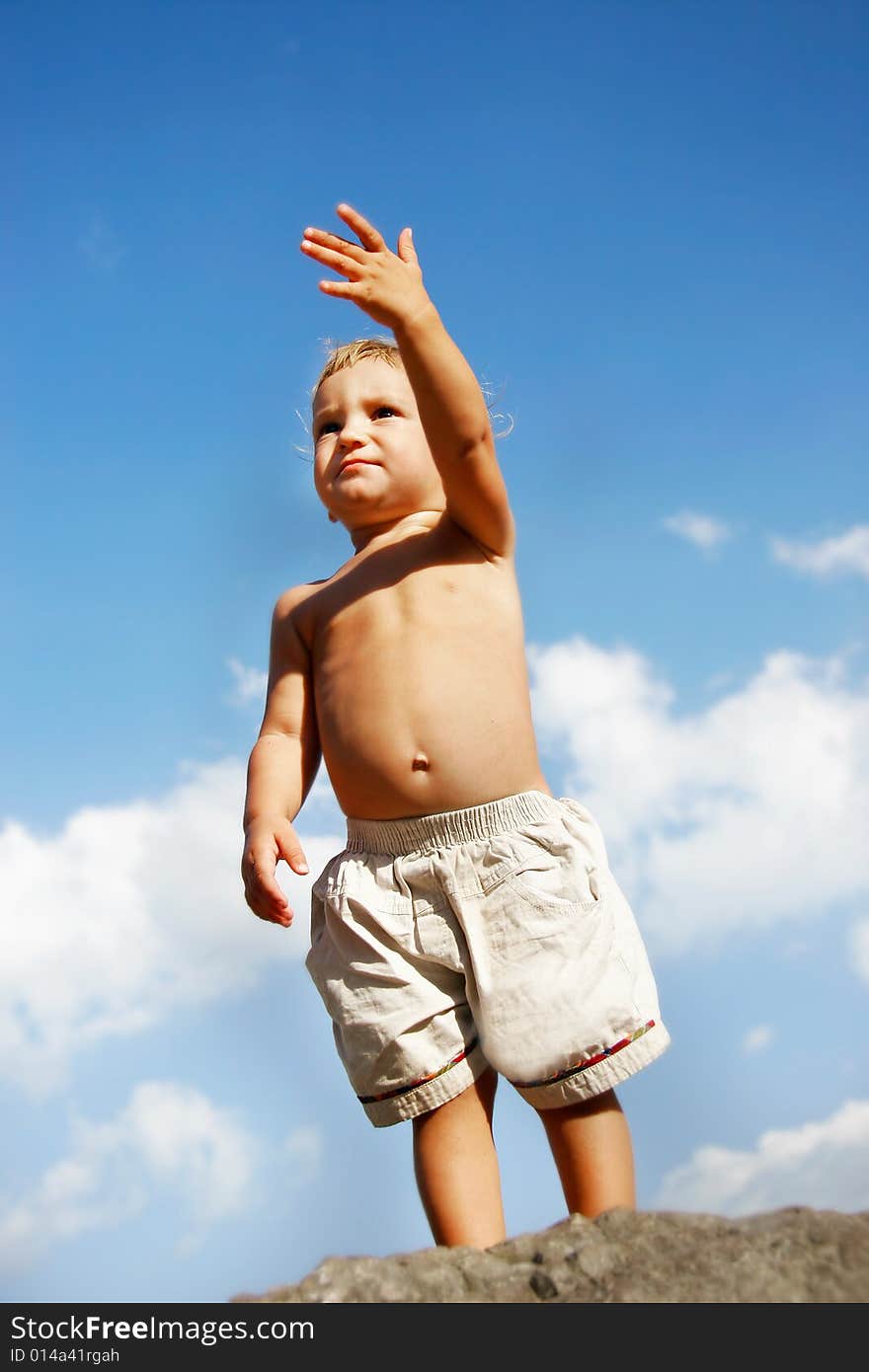 Baby boy on sky background