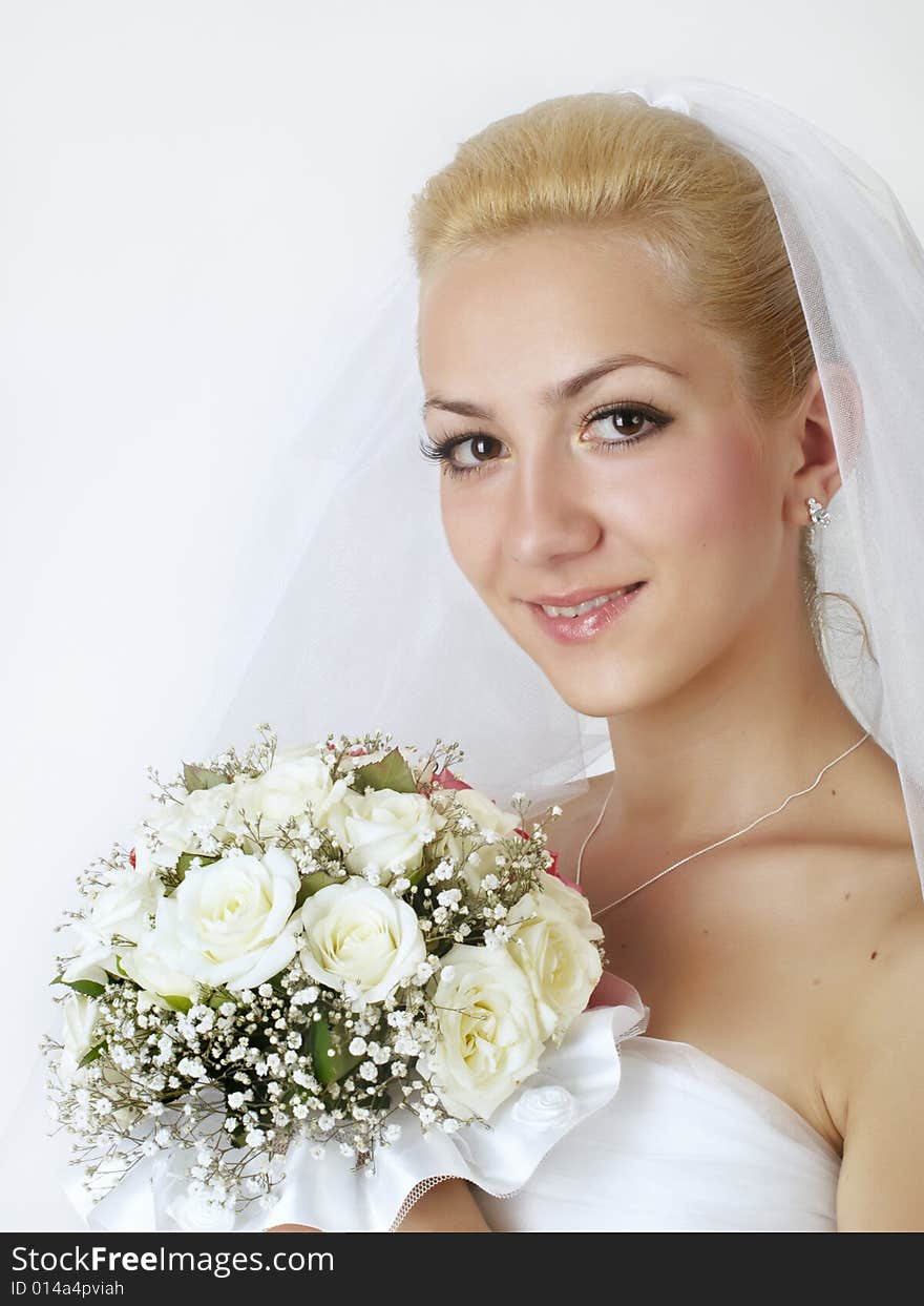 Portrait of beautiful bride with flowers studio shot