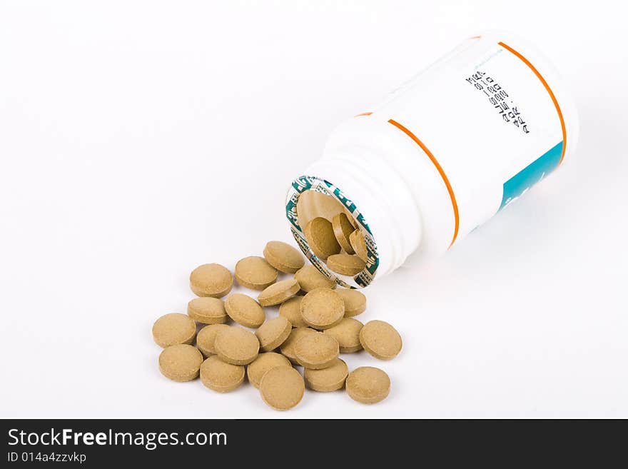 Pills spilling from bottle isolated