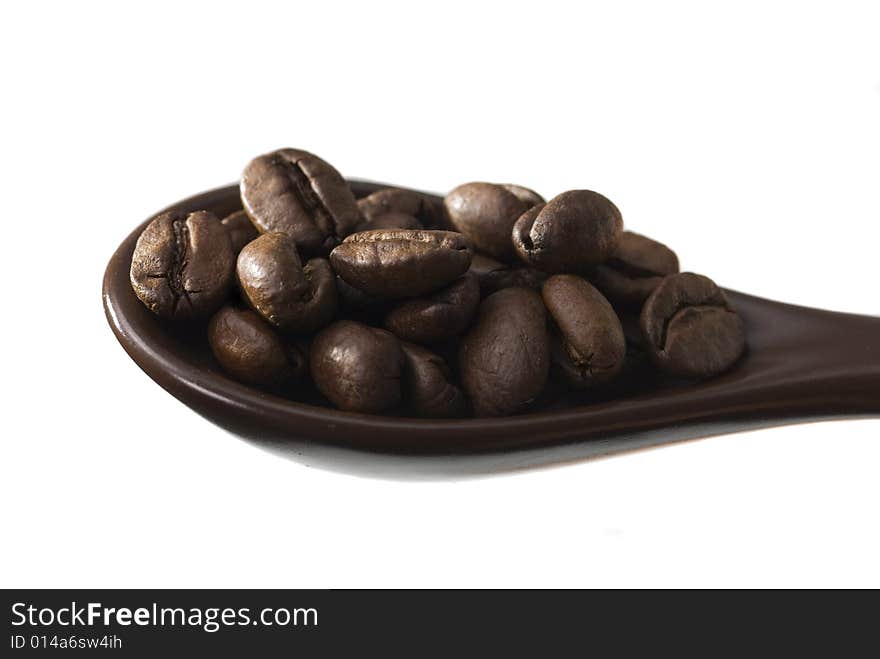 Spoon full of coffee, white background