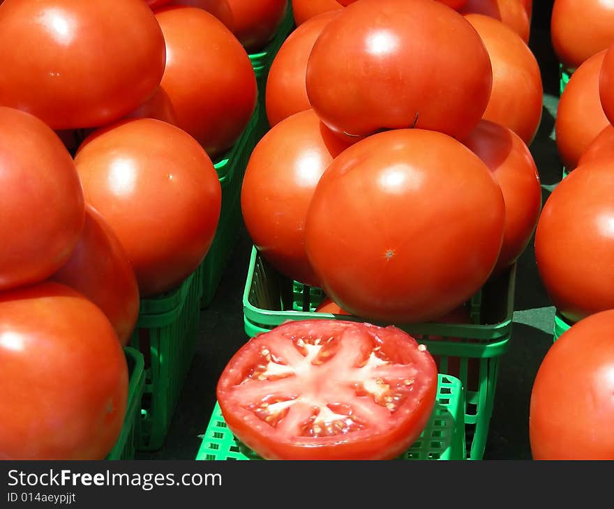 Bright red tomatoes for sale at the local farmer's market. Bright red tomatoes for sale at the local farmer's market.