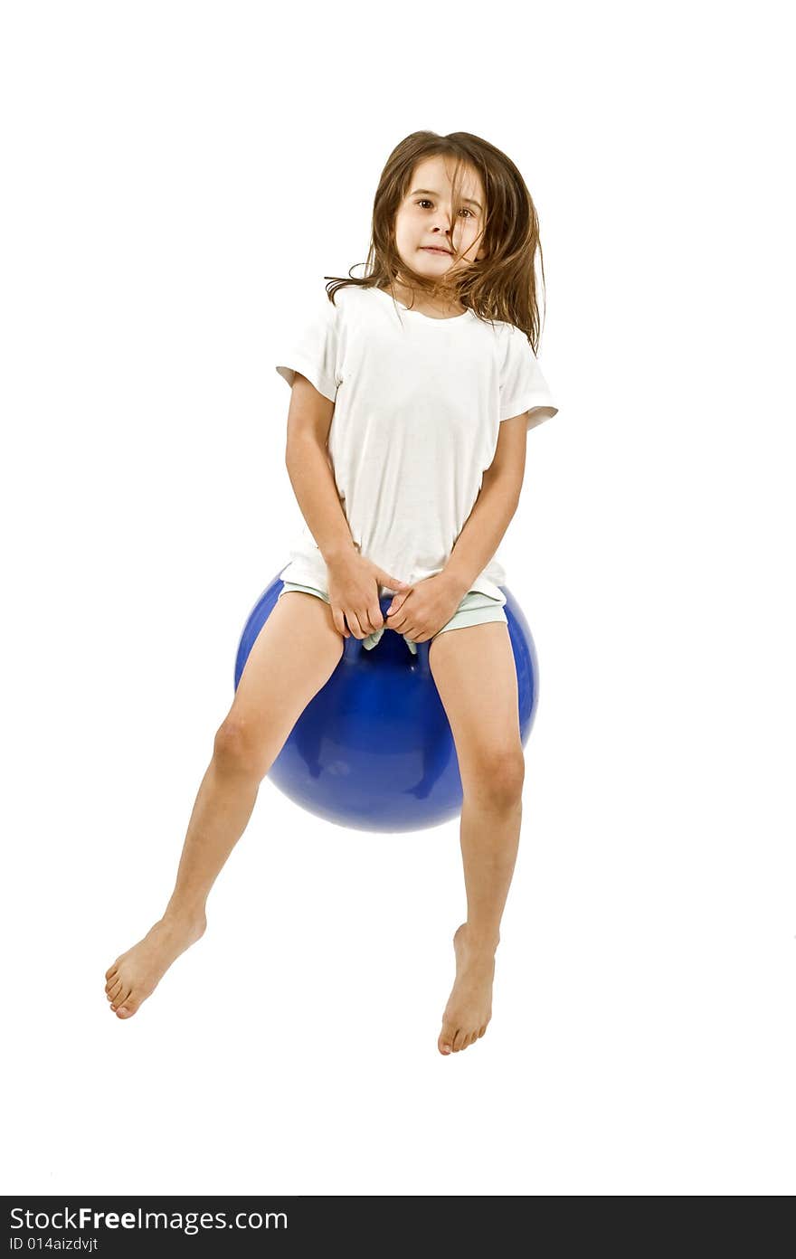 Young girl on a  blue space hopper isolated on white. Young girl on a  blue space hopper isolated on white