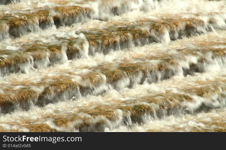 Water rushing down a flight of granite steps, creating abstract horizontal lines and blurs . Water rushing down a flight of granite steps, creating abstract horizontal lines and blurs