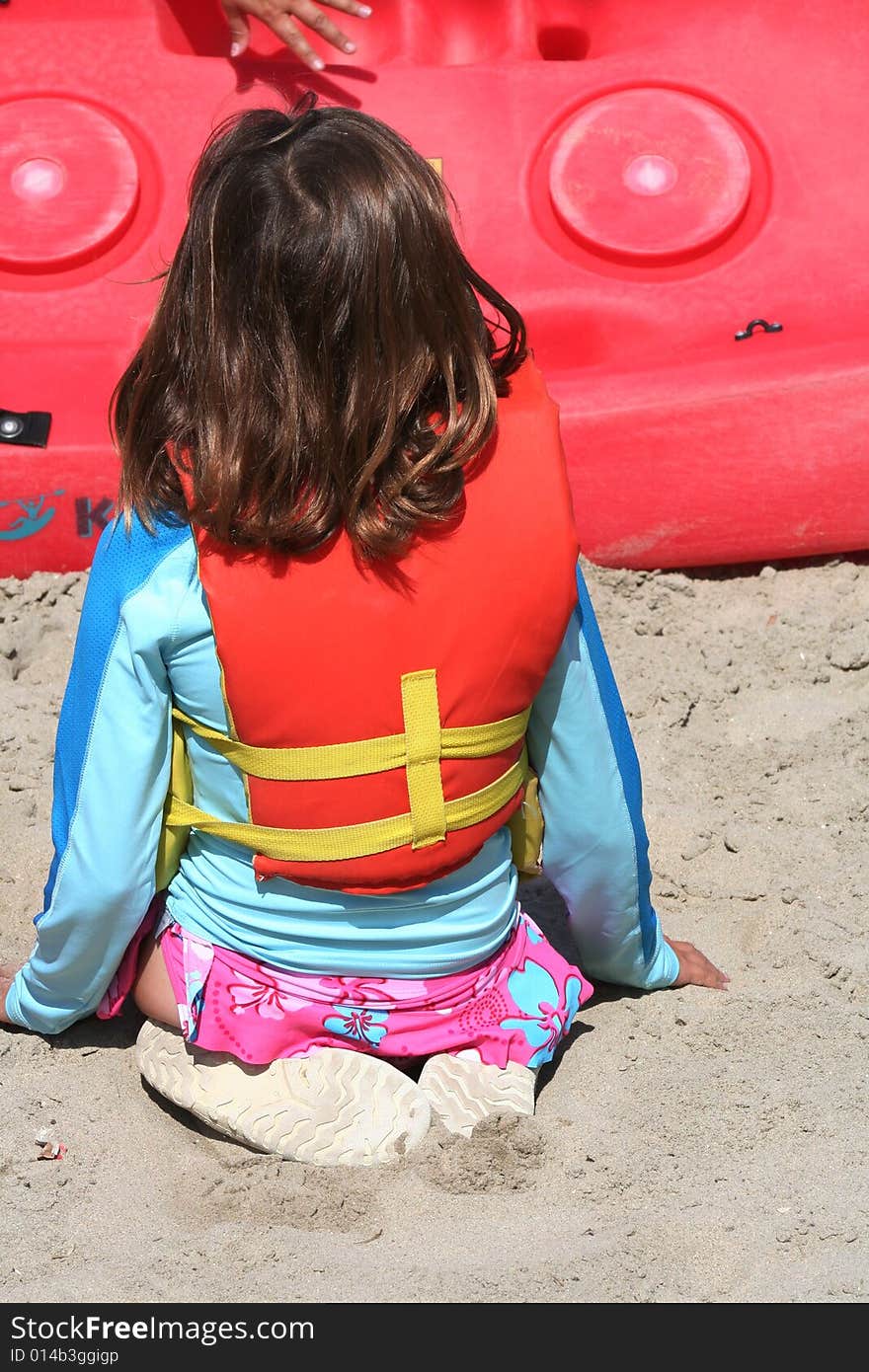 Young girl listening to safety talk wearing a life jacket. Young girl listening to safety talk wearing a life jacket.