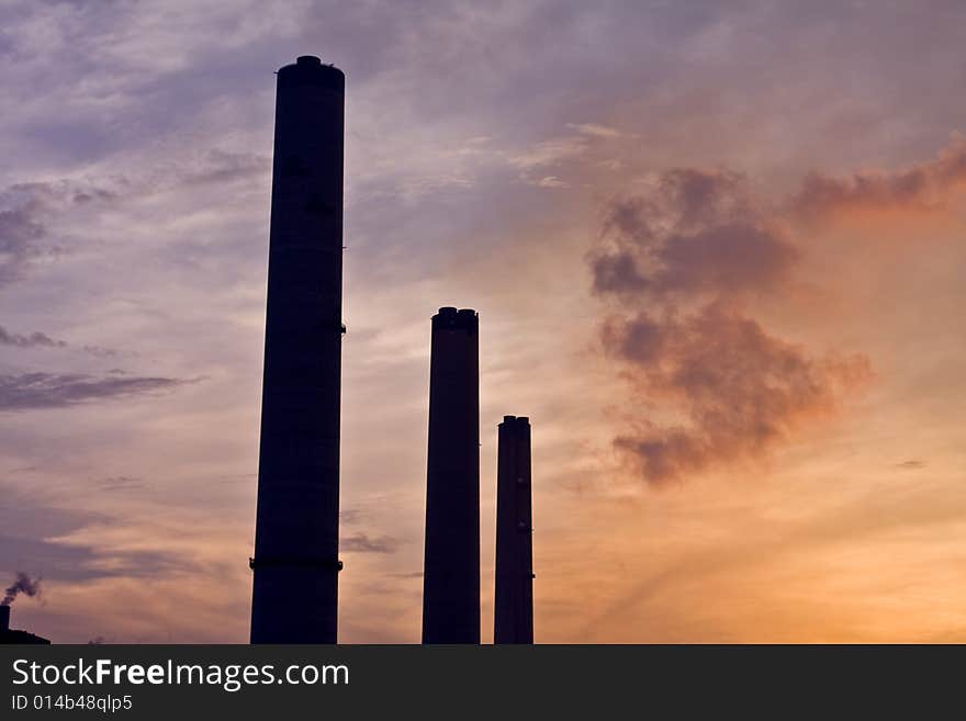 Power station chimneys at sunset with smoke. Power station chimneys at sunset with smoke