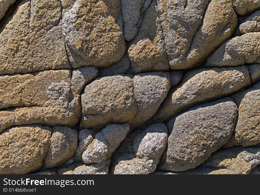 A close-up of the texture of very rough surface of rock on seacoast. Russian Far East, Japanese sea, Primorye. A close-up of the texture of very rough surface of rock on seacoast. Russian Far East, Japanese sea, Primorye.