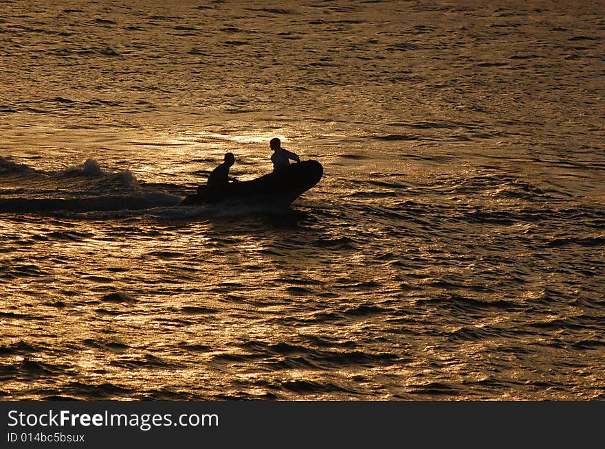 Two men in small rubber boat inside the Bosporuschannel in Istabull heeding for shore. Two men in small rubber boat inside the Bosporuschannel in Istabull heeding for shore