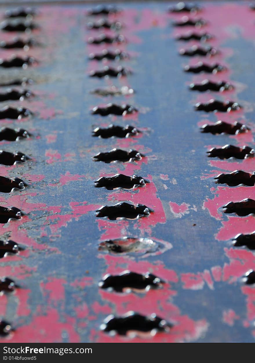 Perforated Metal Sheet With Peeled Red Paint