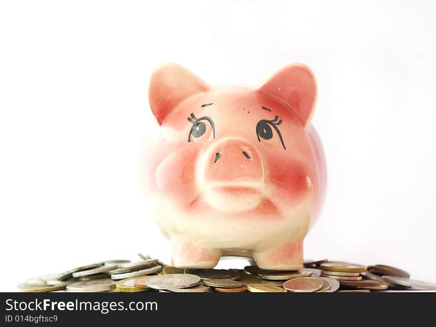 Pink piggy bank isolated on white background with coins