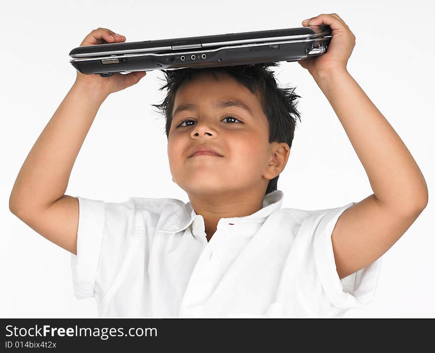 Asian boy holding laptop on his head