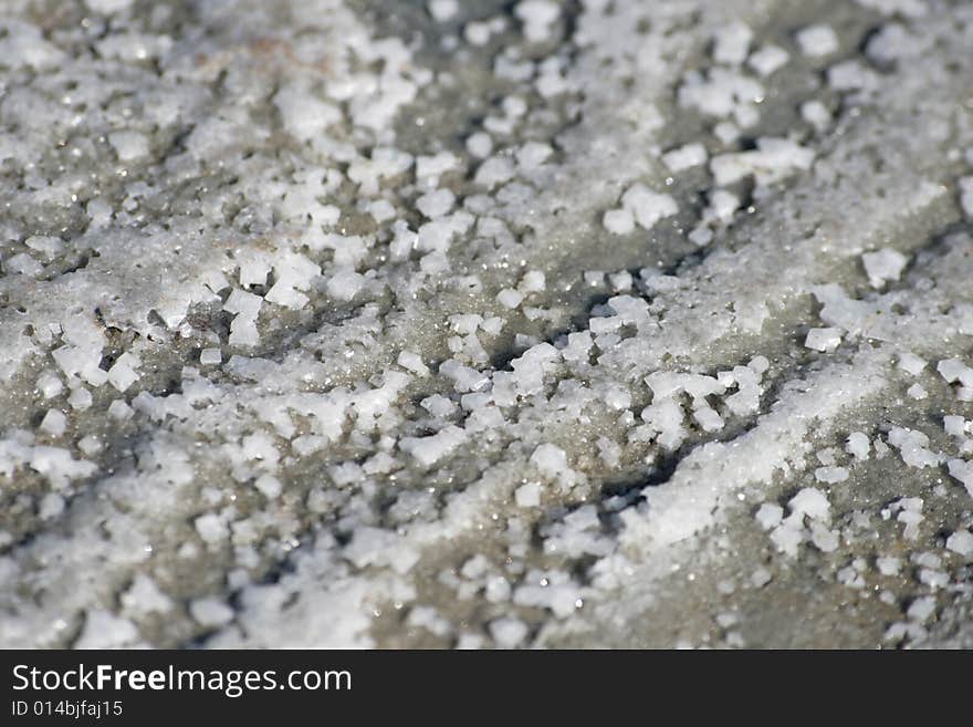 Salt crystals on a grey sand