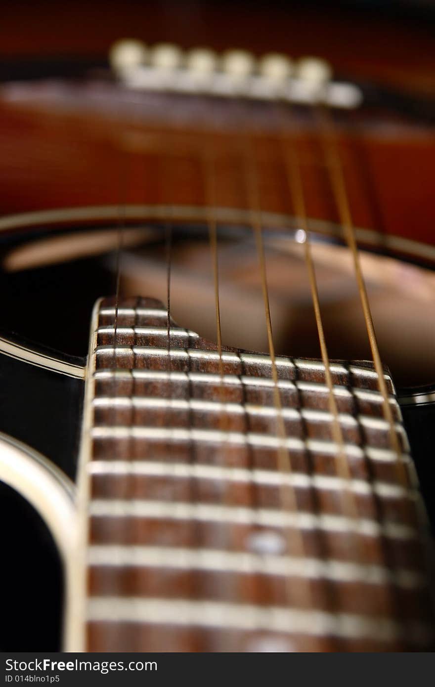 A close up of an acoustic guitar. A close up of an acoustic guitar