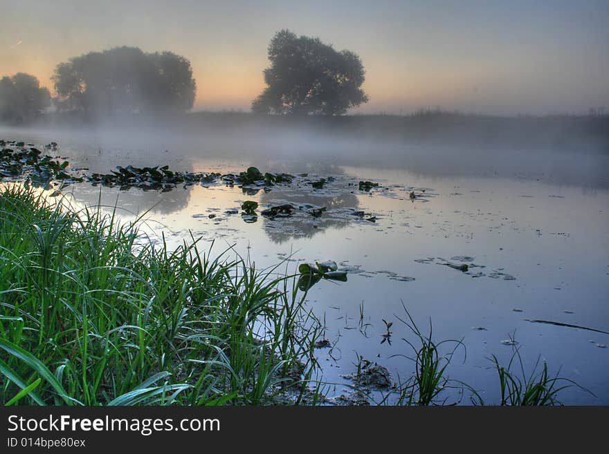 Beautiful foggy river with reflection