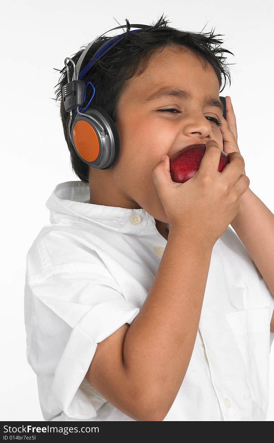 Boy biting a red apple