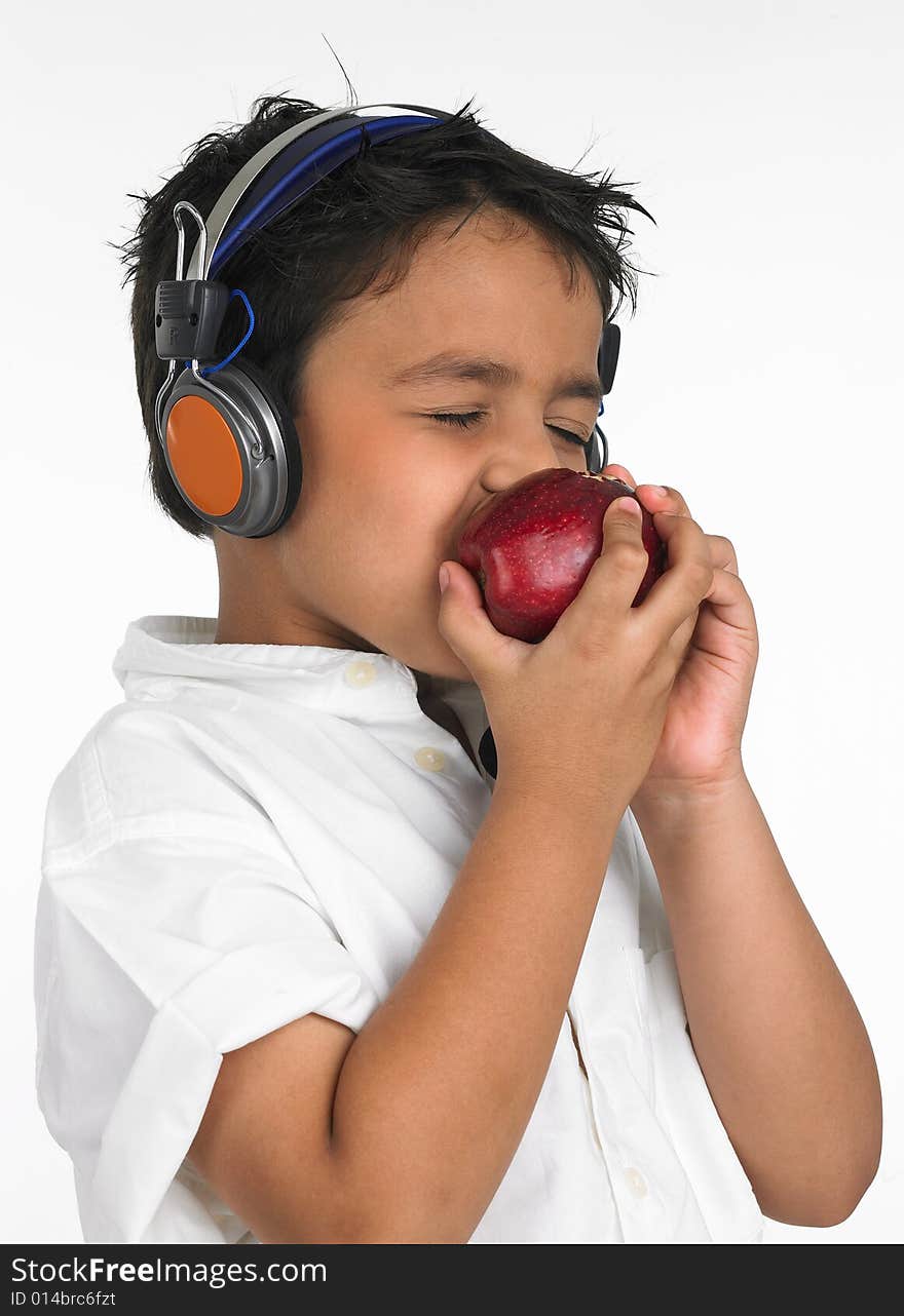 Asian boy biting a red apple