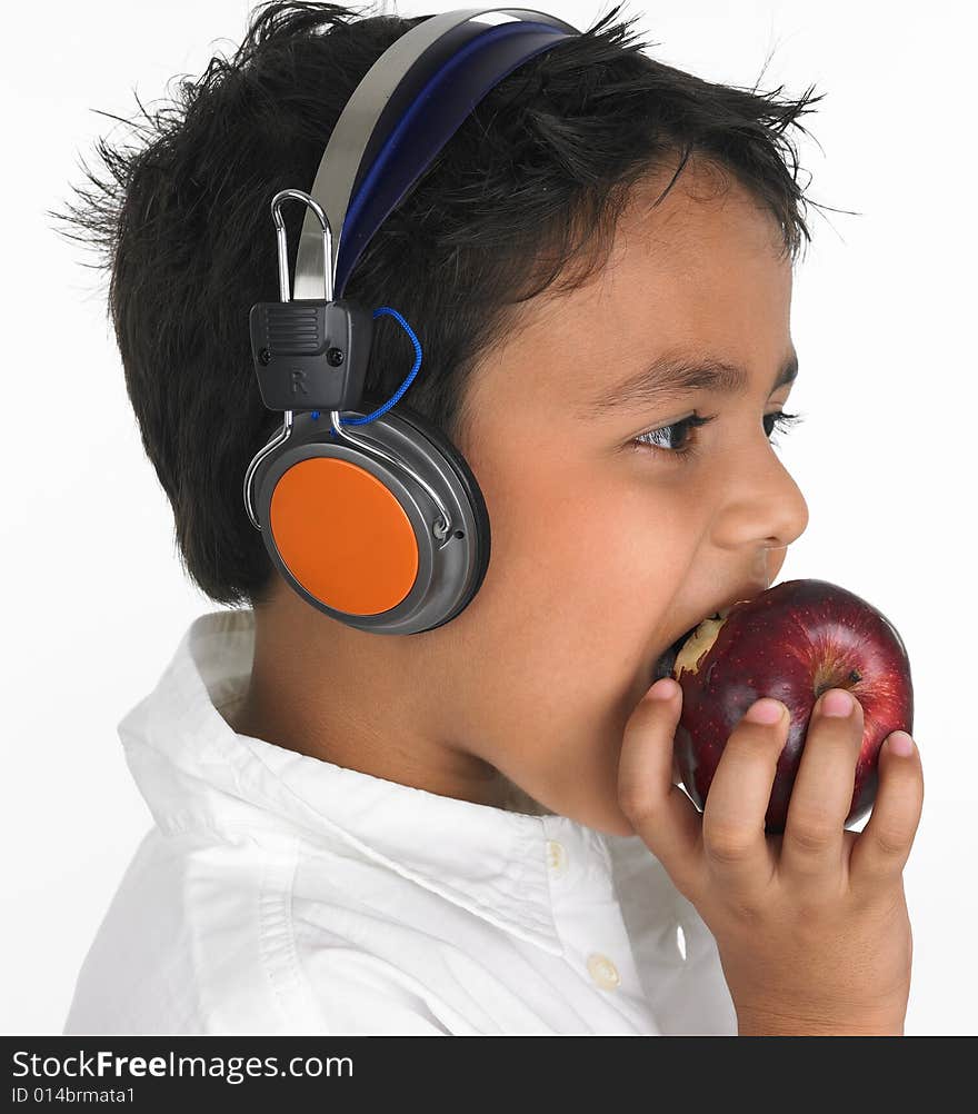 Asian boy biting a red apple