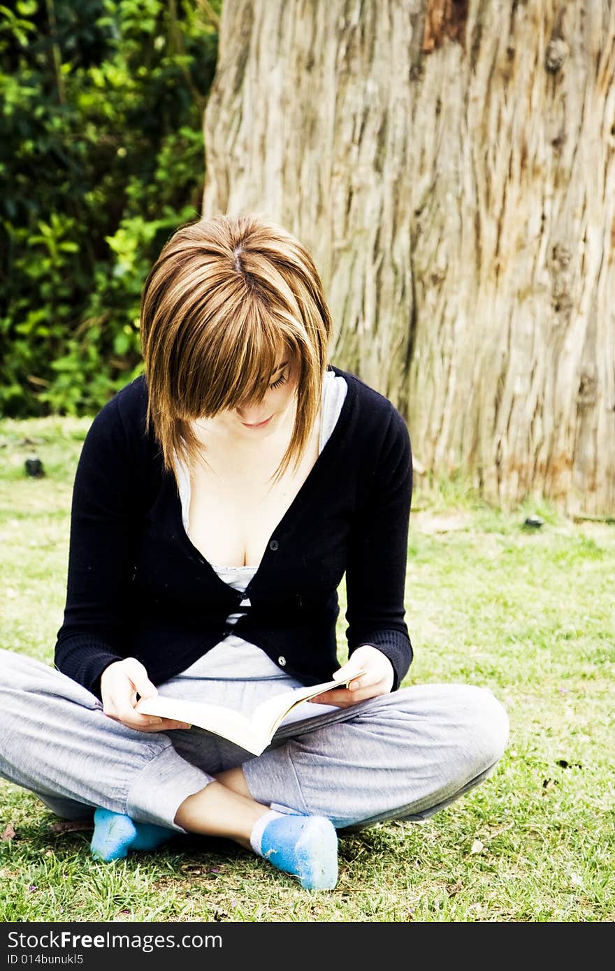 Young Woman Reading In The Park