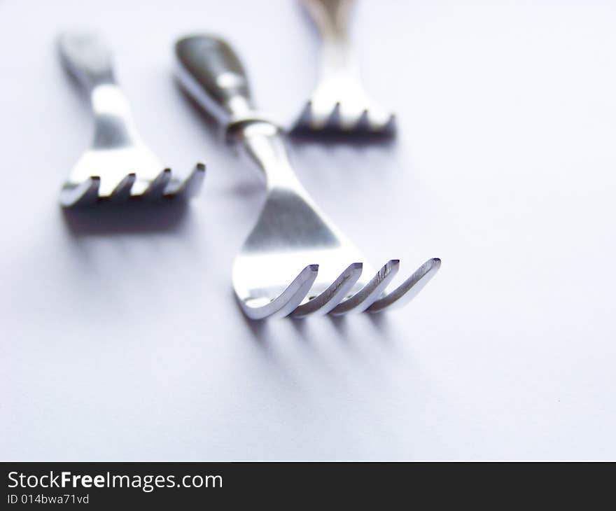 Three forks on a white