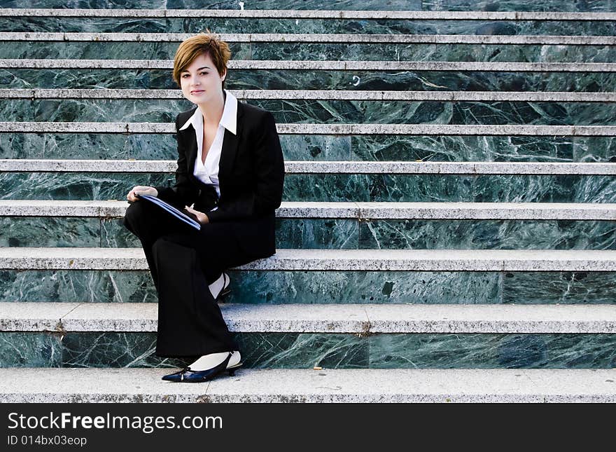 Smiling businessman over marble steps background. Smiling businessman over marble steps background.