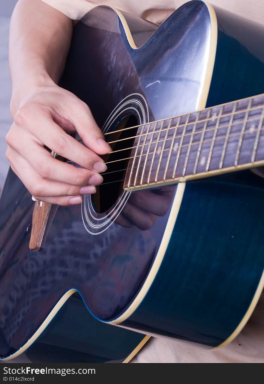 Male hand with classical antique wooden guitar