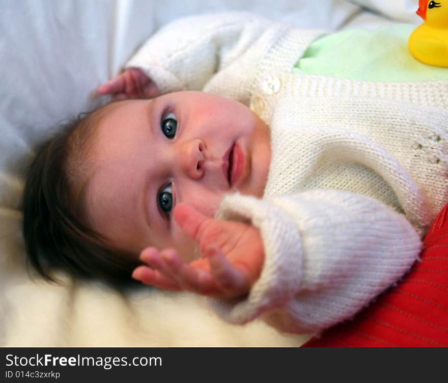 baby lying on back and reaching out. baby lying on back and reaching out