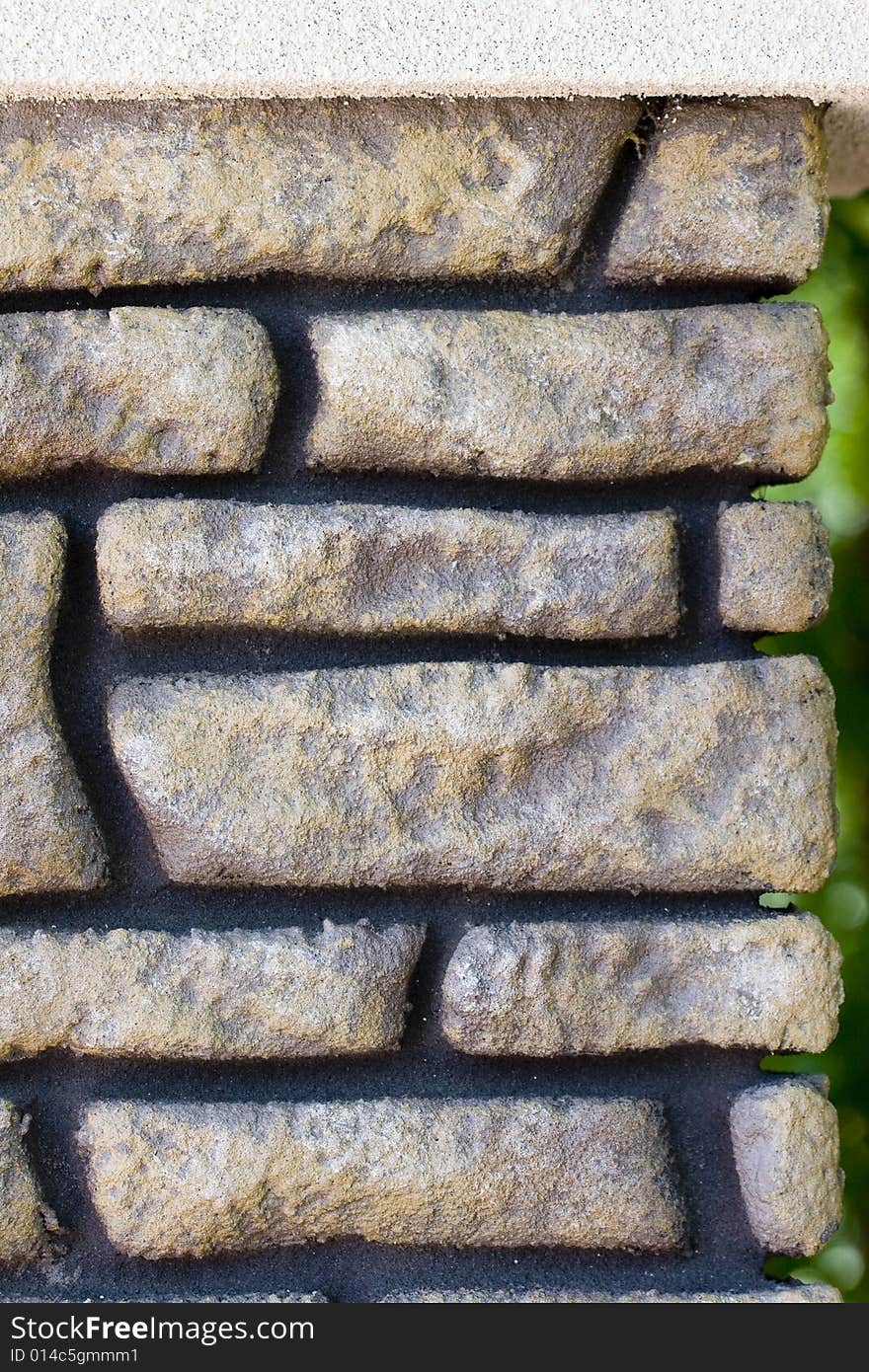 A wall of fake brick and black mortar for a background or texture. A wall of fake brick and black mortar for a background or texture