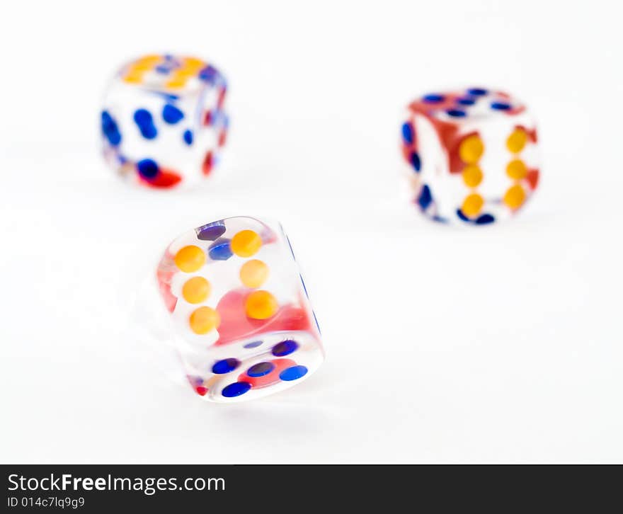 Motion blurred spinning dice against a background of two thrown dice