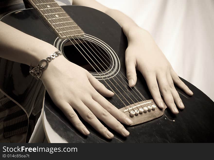 Female hands with antique wooden guitar isolated. Female hands with antique wooden guitar isolated