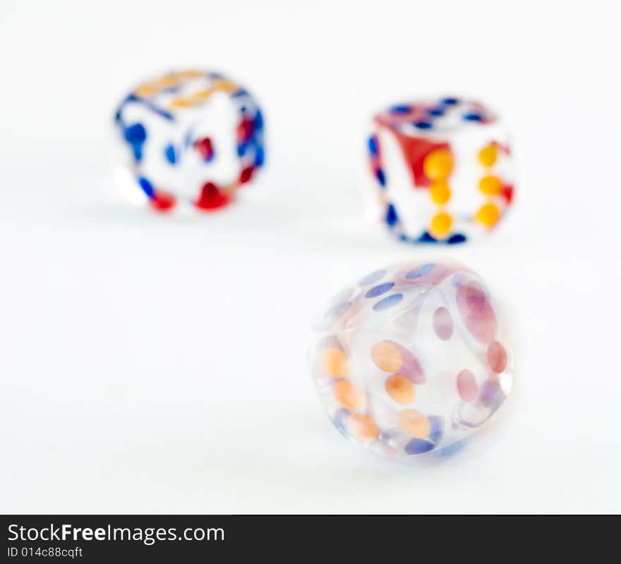 Motion blurred spinning dice against a background of two thrown dice. Motion blurred spinning dice against a background of two thrown dice