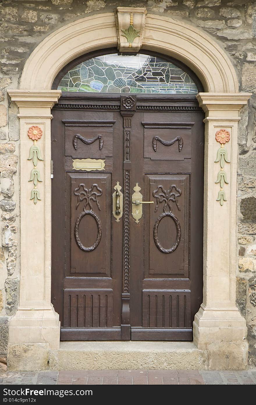 Old double door with carving and brass handle. From Goslar, Germany