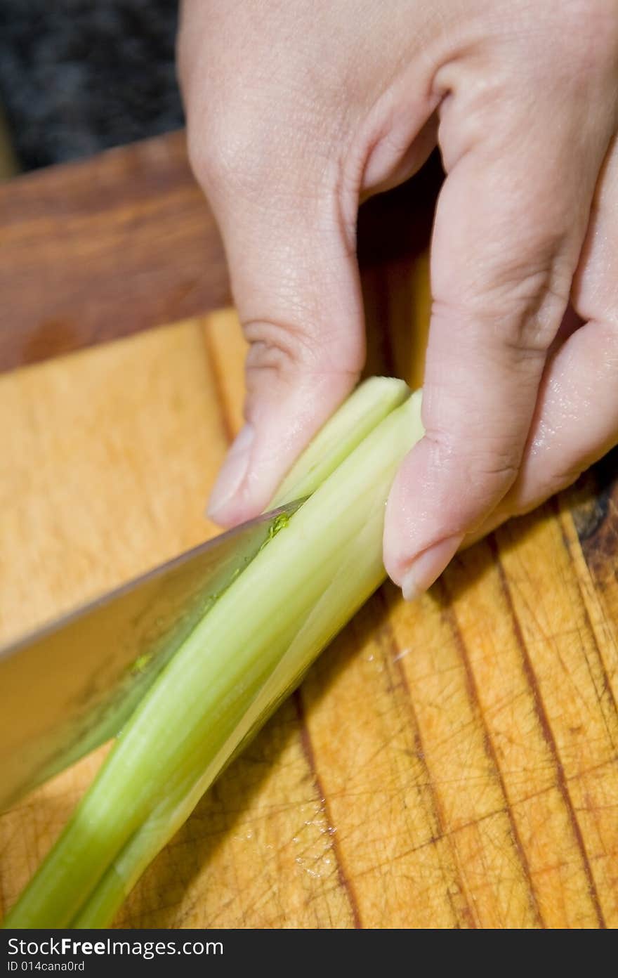 Chef cutting a leek