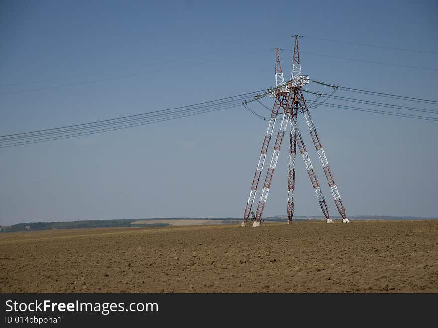 Pillars High Voltage connected electric energy power lines towers in Dobrujda plain Romania