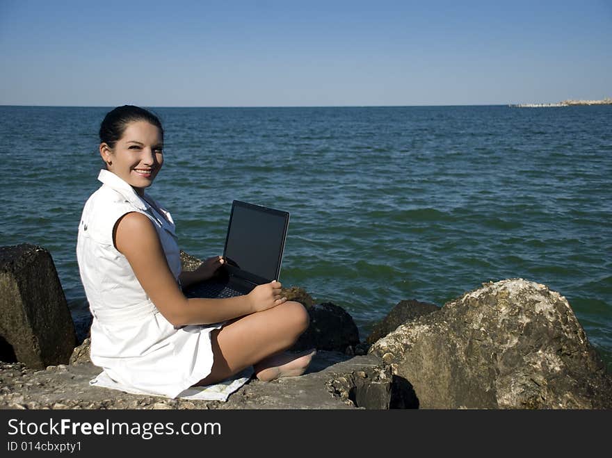 Woman With Laptop On The Beach