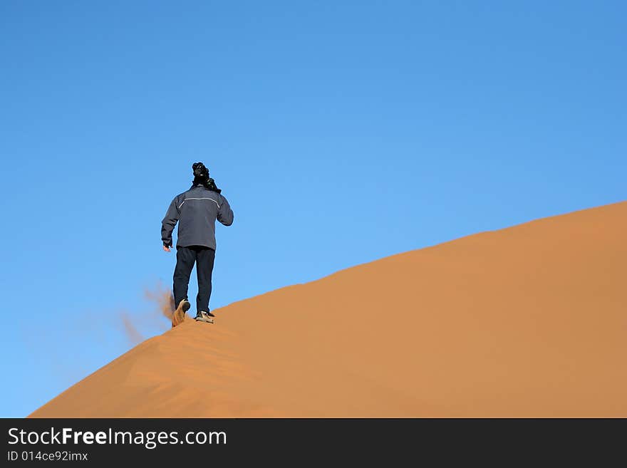 Walking on the sand dune at the desert (Morocco)