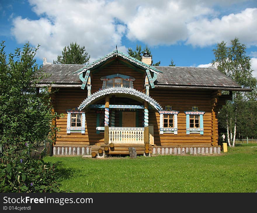 Russian style. Wooden blockhouse on the blue sky background. Russian style. Wooden blockhouse on the blue sky background.