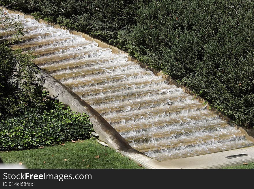 A waterfall over a set of stairs. A waterfall over a set of stairs