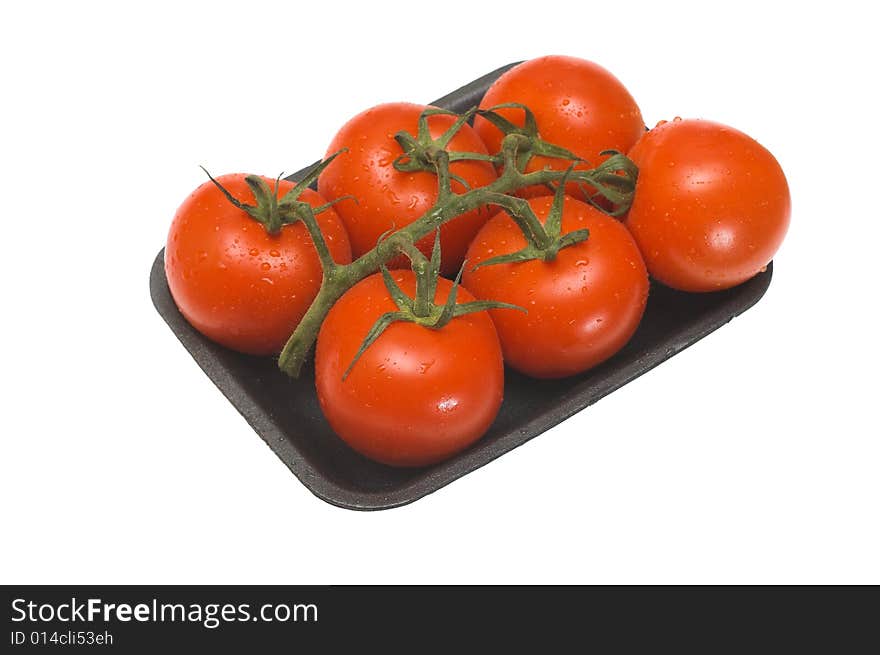 Tomatoes packed in a plastic container on white