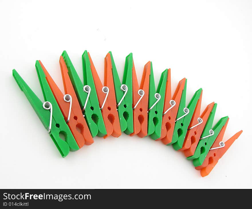 Green and red clothes-pegs isolated over white background.