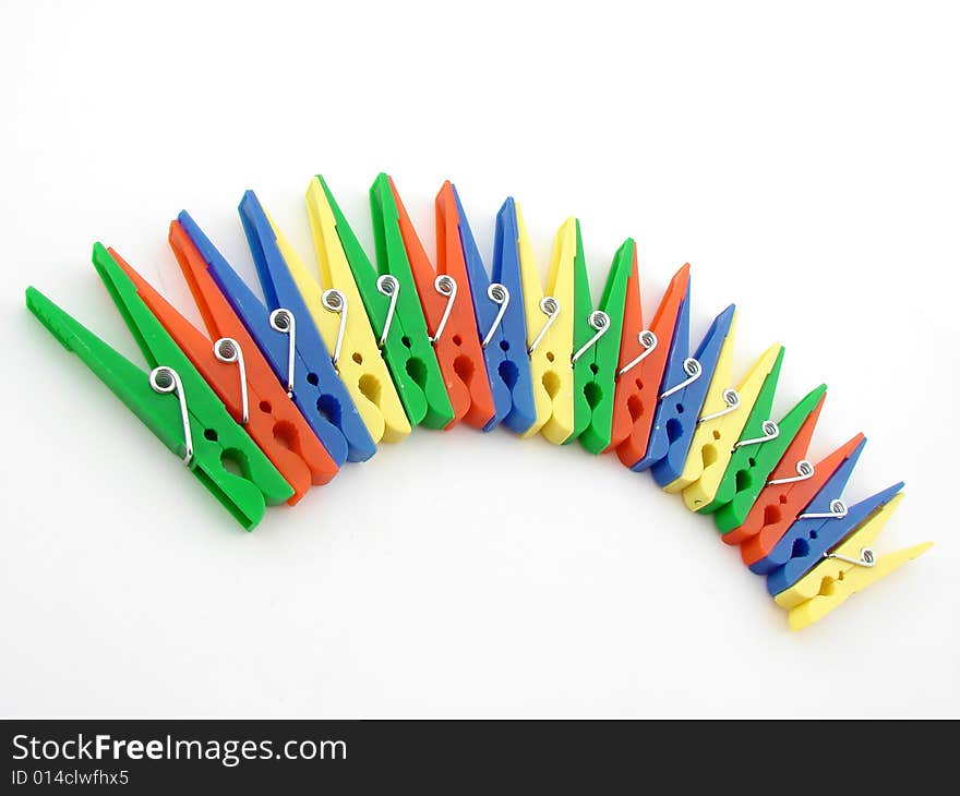 Green, red, blue and yellow clothes-pegs isolated over white background.