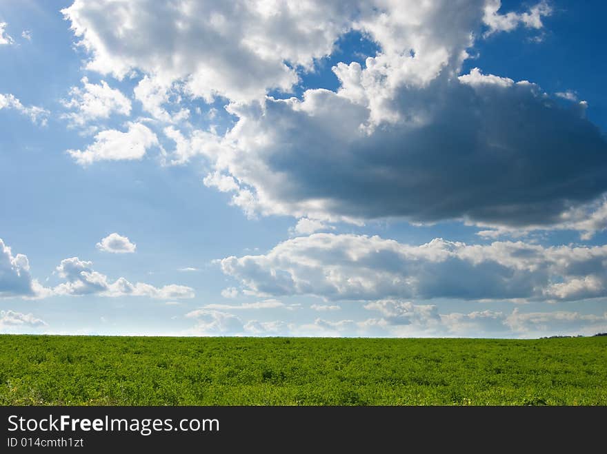 Dramatic clouds over a green pasture. Dramatic clouds over a green pasture