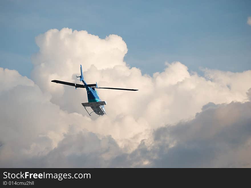 Helicopter flying off into the clouds